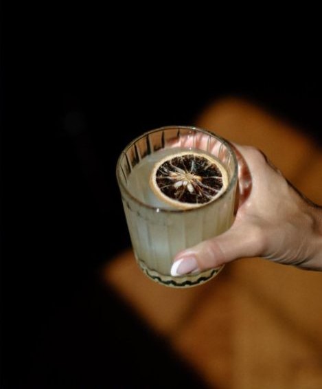 A cocktail with a dried citrus wheel